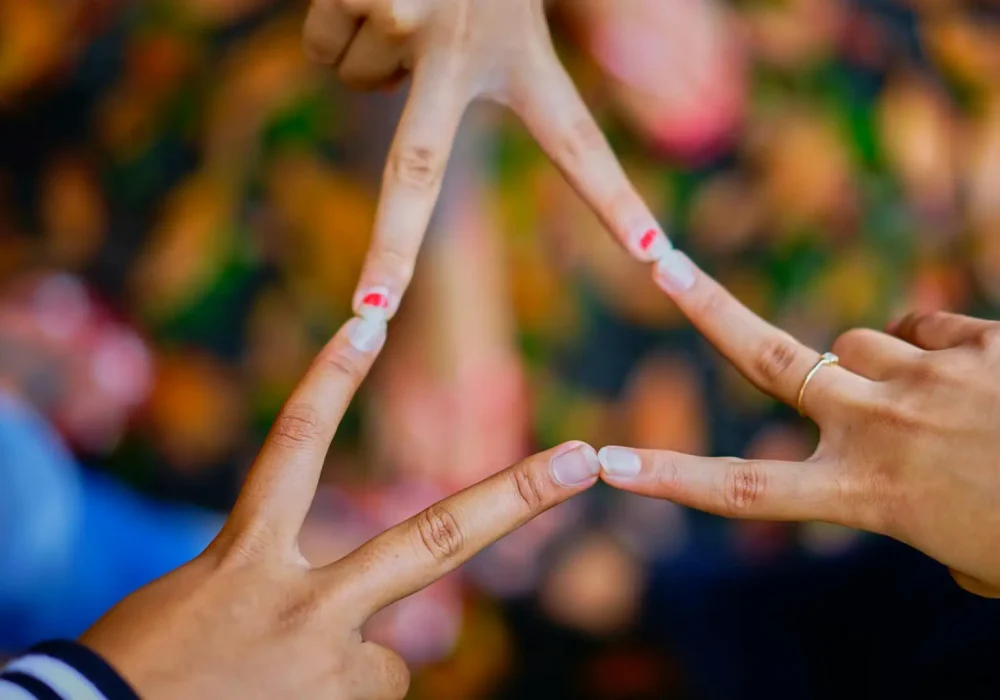Close-up of hands forming a star shape, symbolizing unity and friendship.