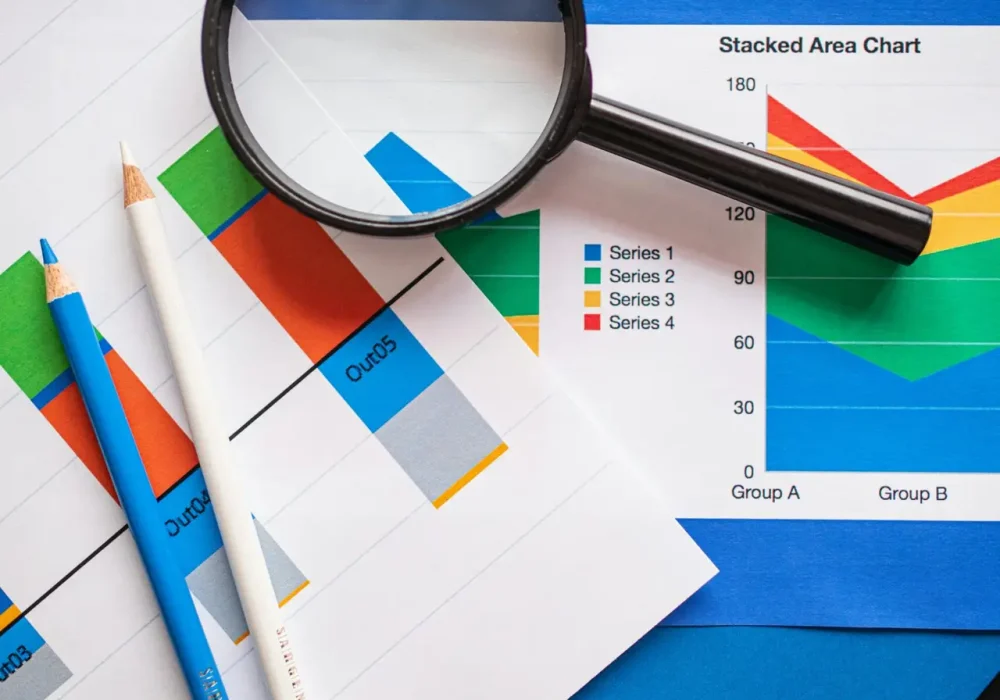 Image of financial charts and magnifying glass, ideal for business insights.